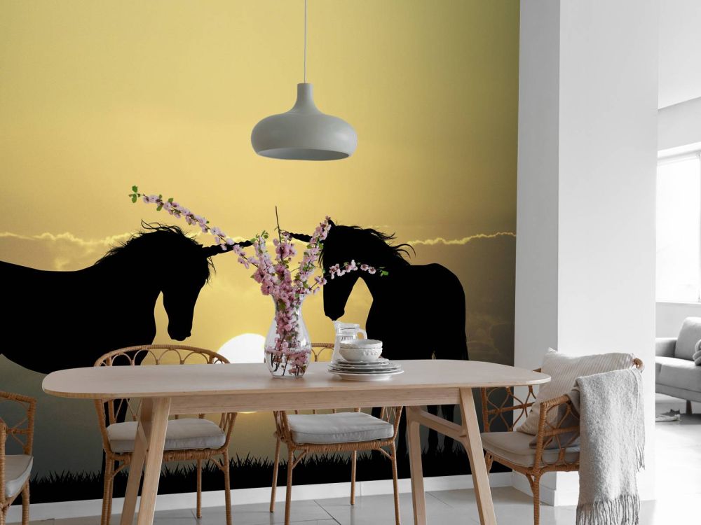 Unicorns bij een zonsondergang