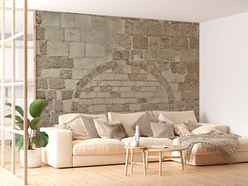 Oude stenen muur met boog